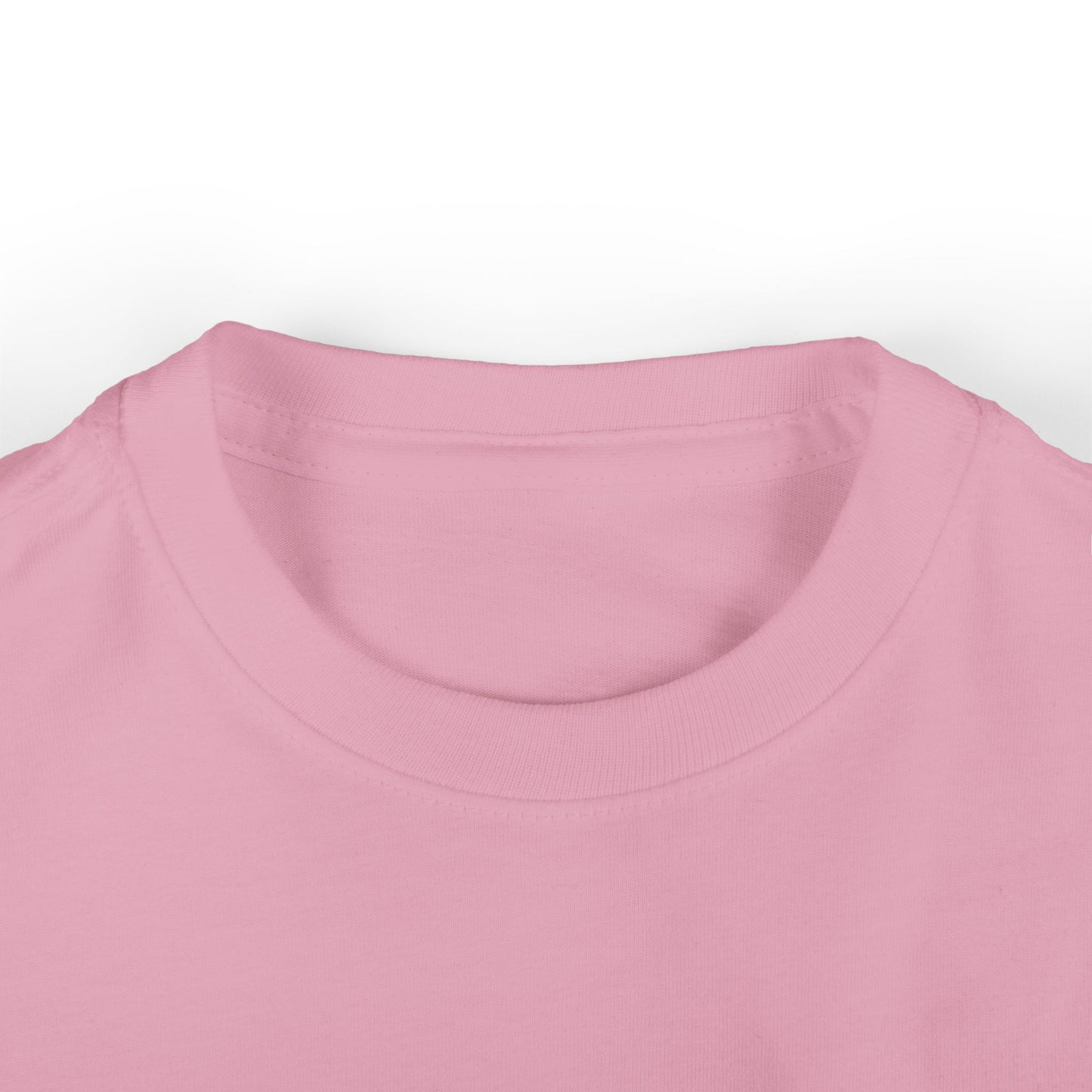 Close-up of an infant tee in soft pink cotton on a white background, highlighting the round neckline and fabric texture.