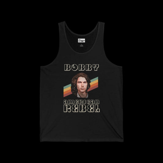 This retro vintage black tank top showcases a graphic design with the text BOBBY American Rebel. Below, a long-haired 70's Bobby Kennedy Jr. complements the look. Behind Kennedy Jr. are vibrant stripes in orange, yellow, and teal completing this unisex jersey tank tops bold statement.