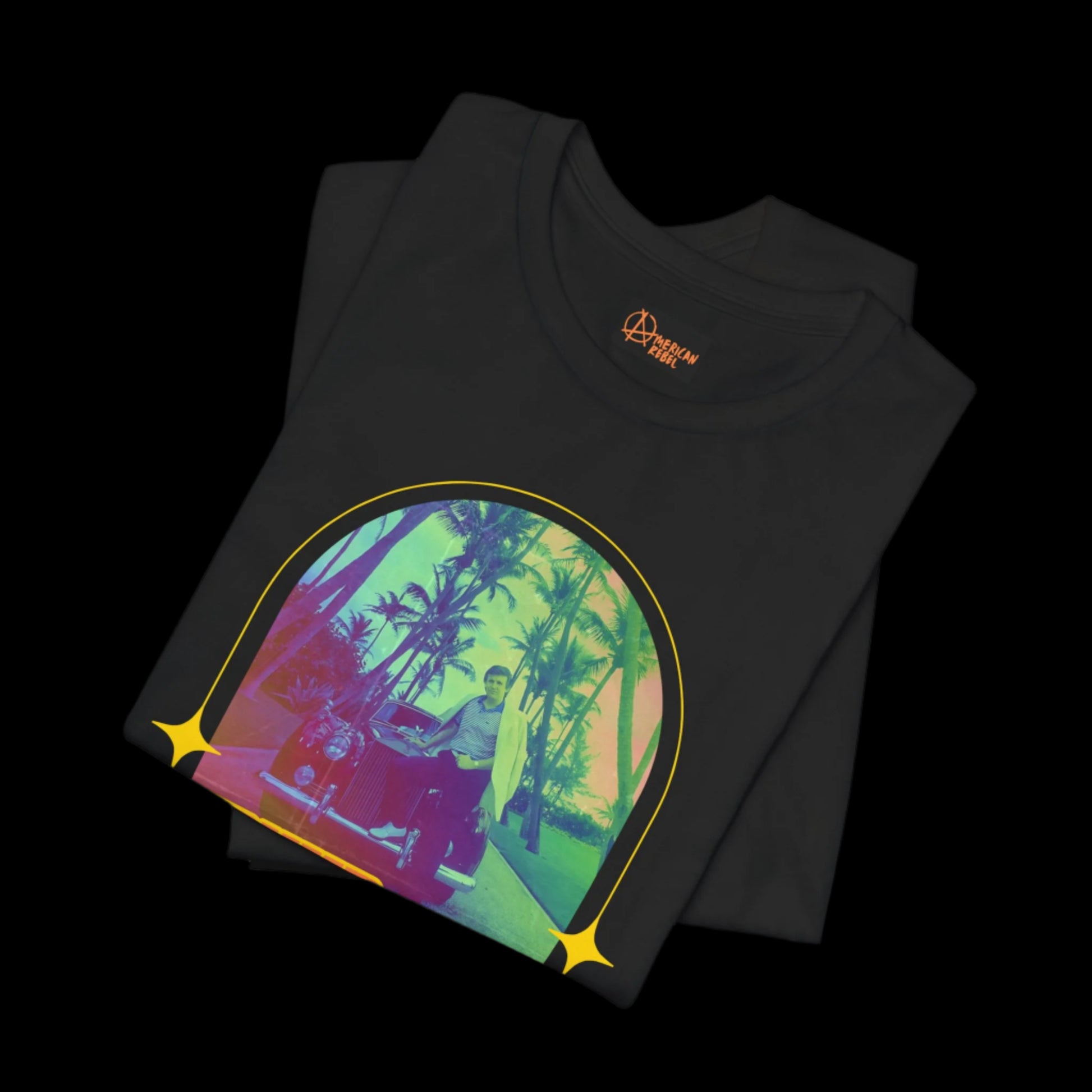 This black retro vintage tee showcases a colorful, stylized vintage image of Trump standing by his car with rainbow palm trees in the background. The design, framed in a circular pattern with star-like accents, is crafted from 100% cotton.