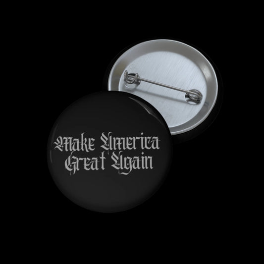 A black button, labeled Make America Great Again in a gothic font, exudes a gothic-dark aesthetic. The MAGA-pin is open, revealing its metal pin-back closure against the black background.