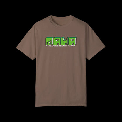 The Make America Healthy Again MAHA unisex t-shirt features bold green text with white accents on an espresso brown, 100% cotton garment-dyed fabric. Its retro block-style font creates a vintage look.