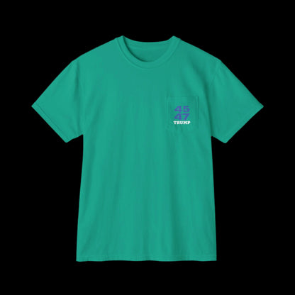 A garment-dyed island green T-shirt features a pocket on the left chest, printed with Trump 45 47 in a blue with white star pattern and the text TRUMP below, reminiscent of sports jersey t-shirts. Displayed against a black background, it combines casual style with unique detailing.