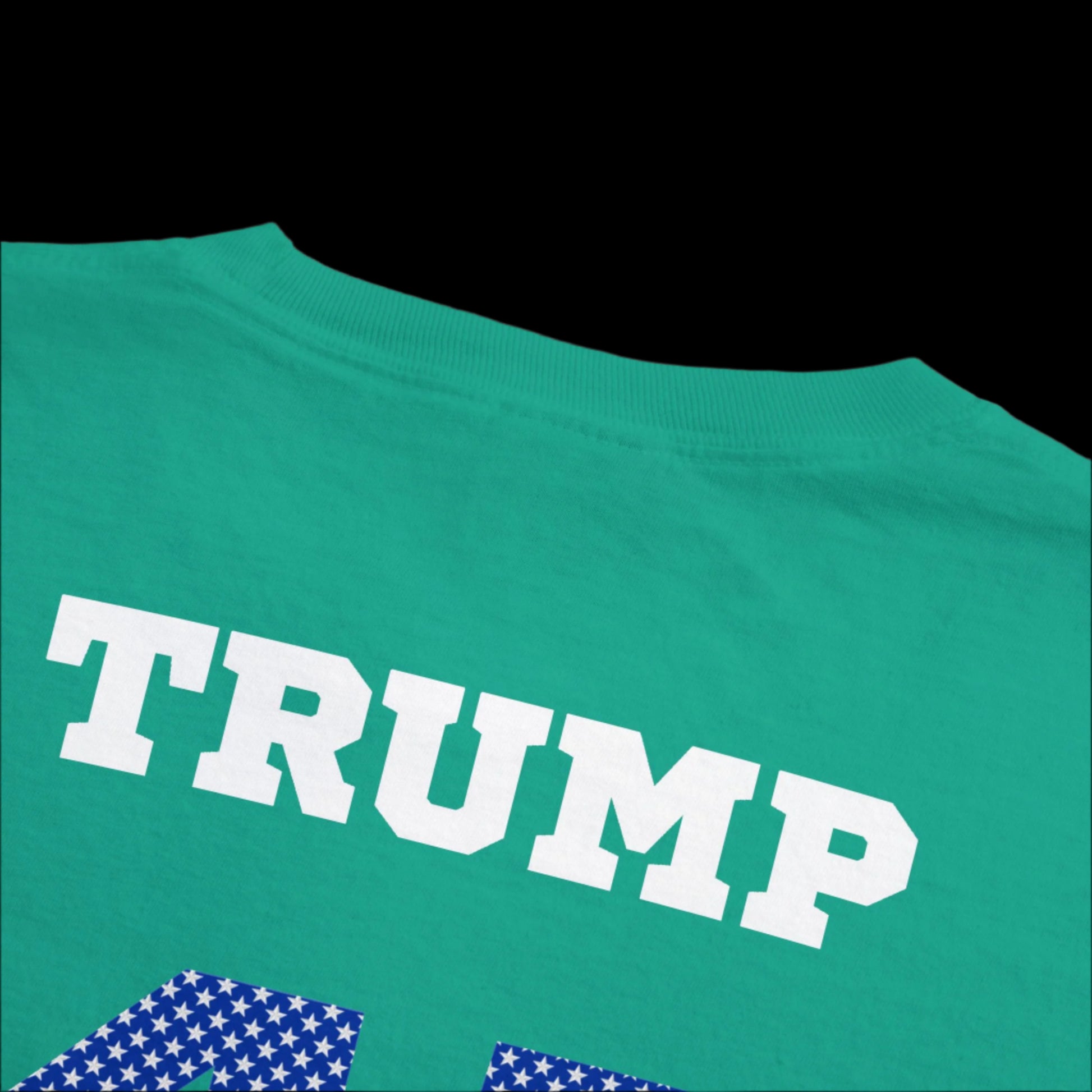 This garment-dyed island green t-shirt resembles a classic sports jersey t-shirt, featuring TRUMP 45 47 in bold white capitals on the back, with a partial number adorned with an American flag pattern below.