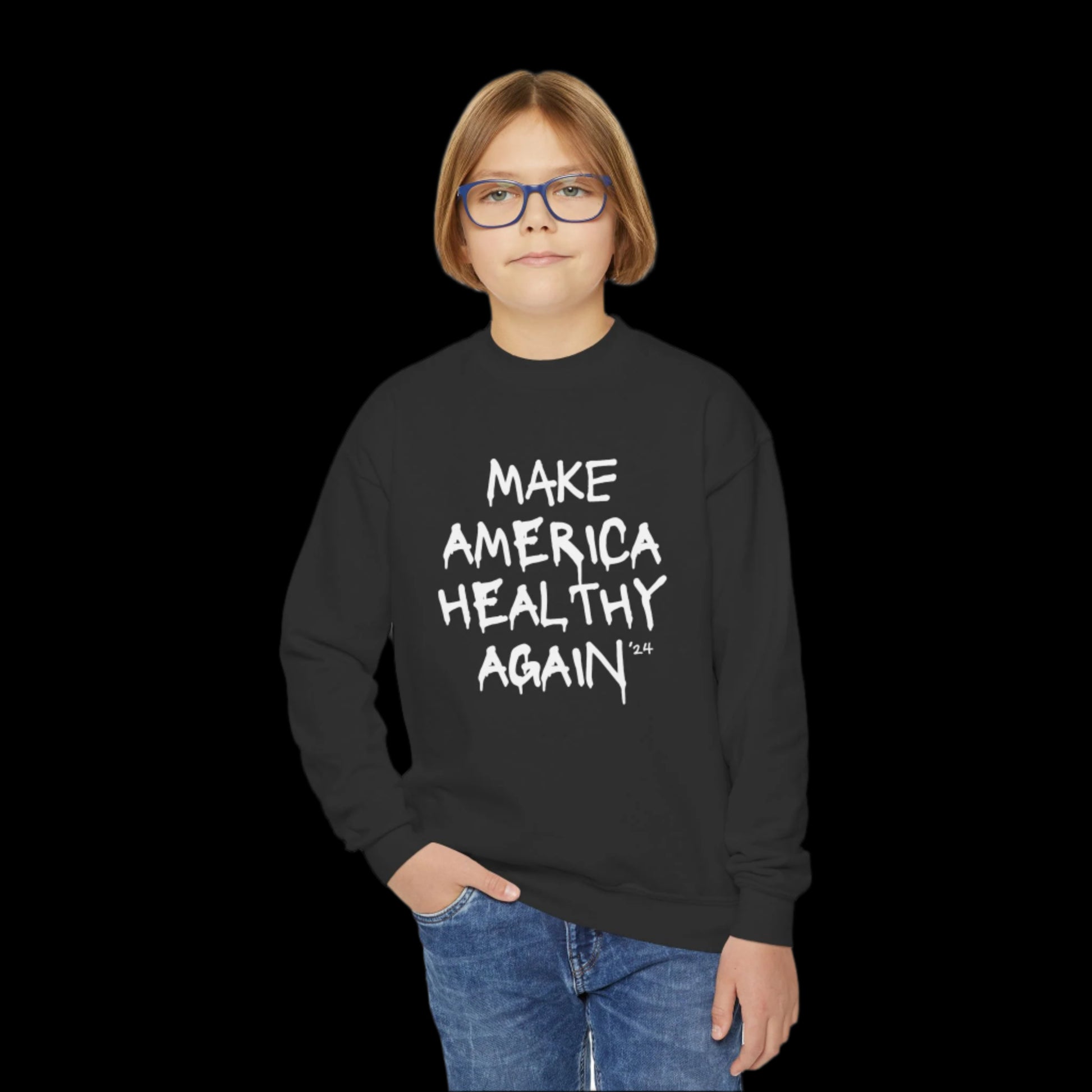 A young person with glasses dons a black sweatshirt emblazoned with MAKE AMERICA HEALTHY AGAIN 24. With one hand in their pocket, they stand confidently against a plain white backdrop, embodying RFK Jr.s vision for a toxic-free environment.