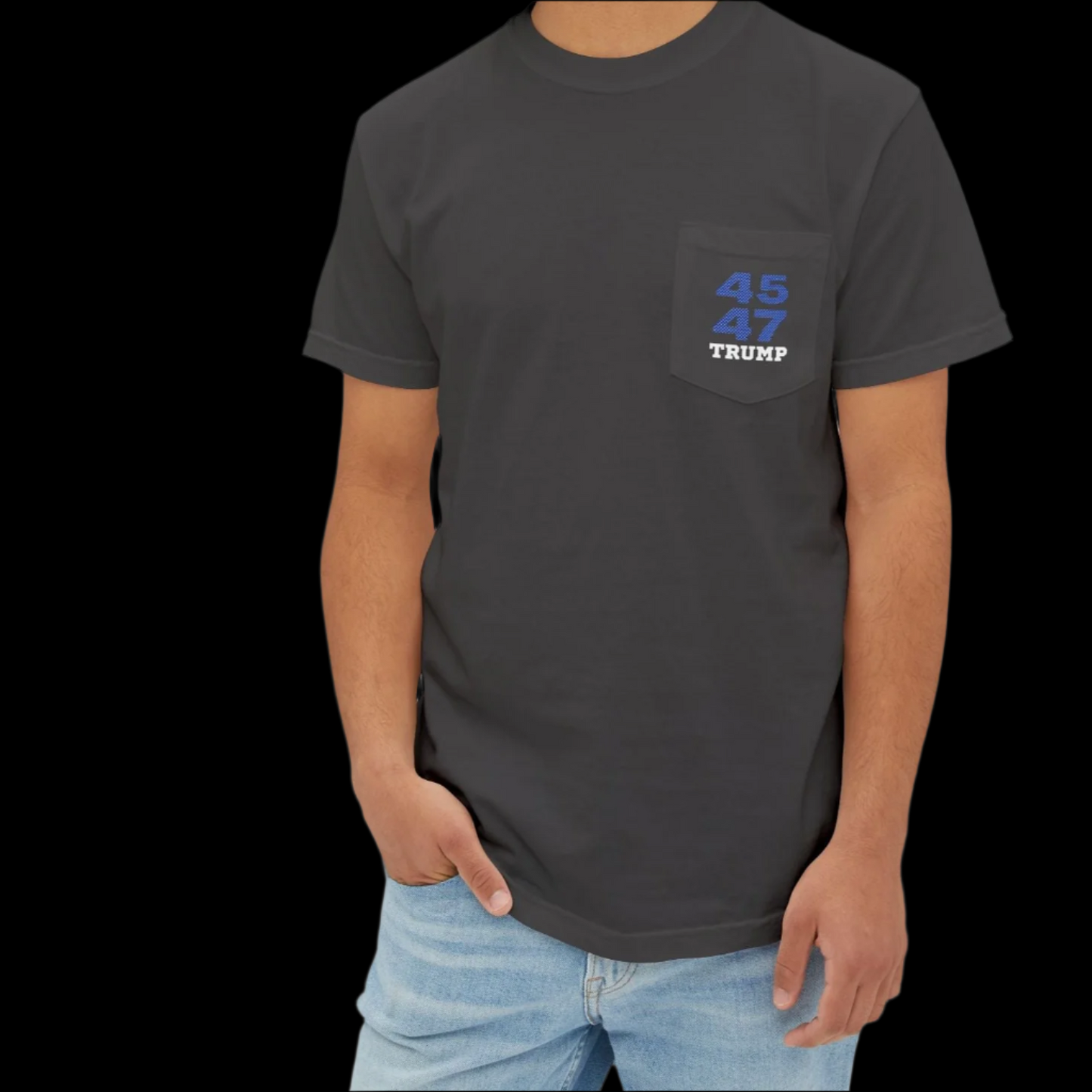 A man is sporting a graphite garment-dyed t-shirt with Trump 45 47 on the pocket area, reminiscent of sports jersey t-shirts, paired with light blue jeans. The shirt nods to Donald Trump as the 45th and 47th president.