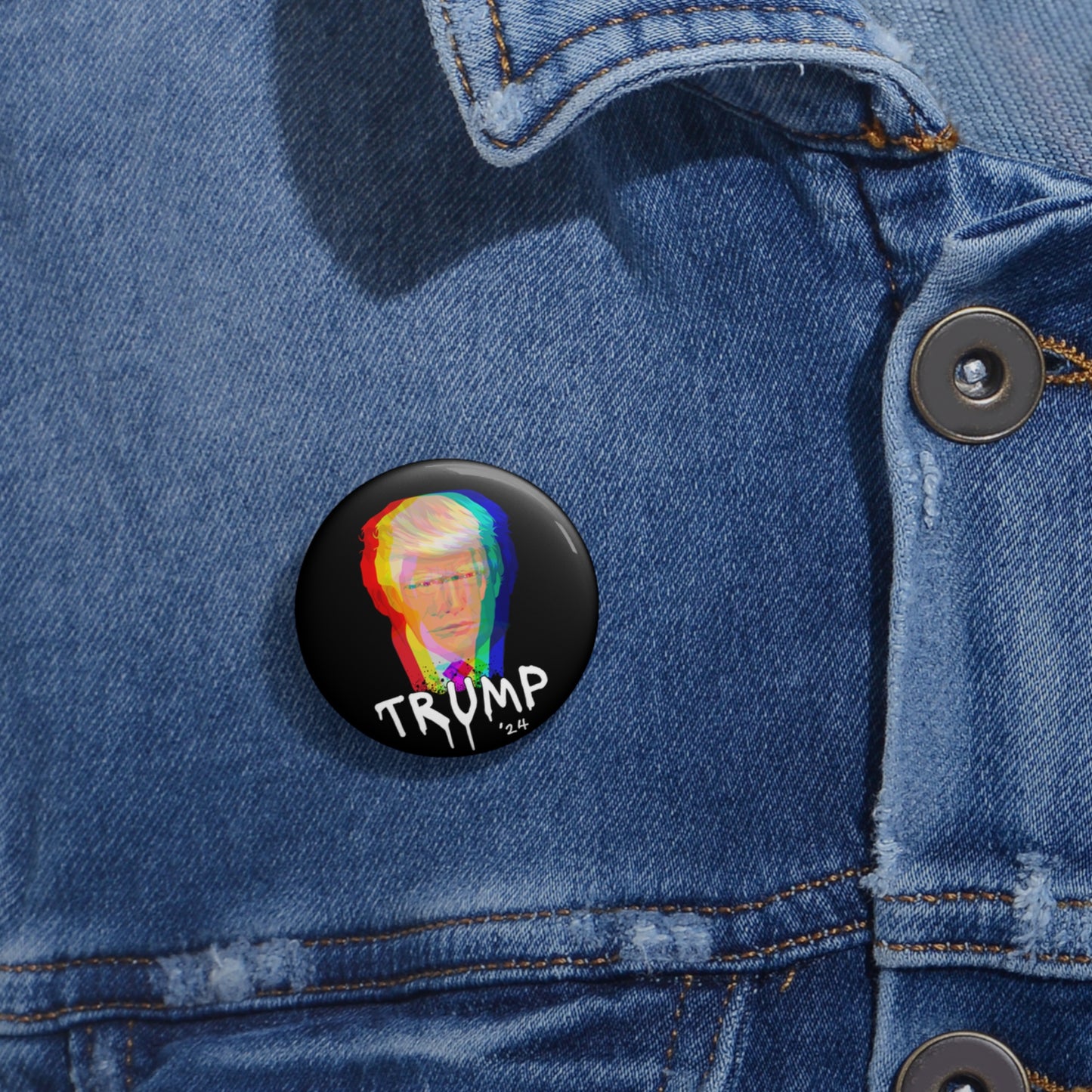 A denim jacket with a stylish pin button on the pocket. The button showcases a vibrant, graffiti art-style portrait of Donald Trump UV resistant for lasting color, with TRUMP text beneath.