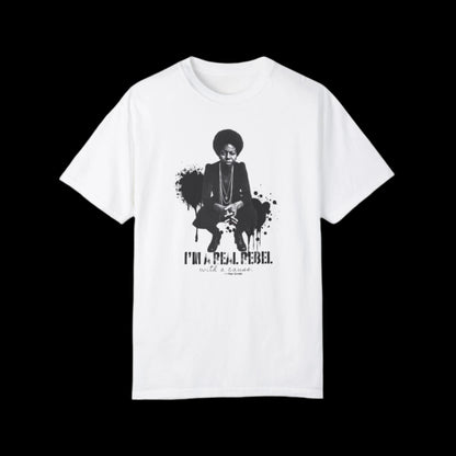 This unisex T-shirt boasts a vintage look with a monochrome graphic of Nina Simone squatting with her hands crossed, accompanied by the text I'm a rebel with a cause below. Black paint splashed in the backgroud. Inspired by fans of Nina Simone, the graffiti art design stands boldly against the black background.