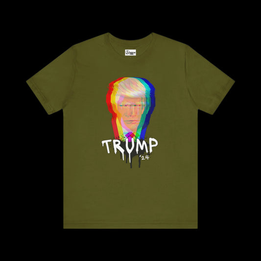 Olive green unisex cotton tee featuring a stylized, multicolored image of Trump's face with the word TRUMP 24 beneath it, designed in a graffiti art dripping paint effect. Crafted from breathable fabric for comfort and style.