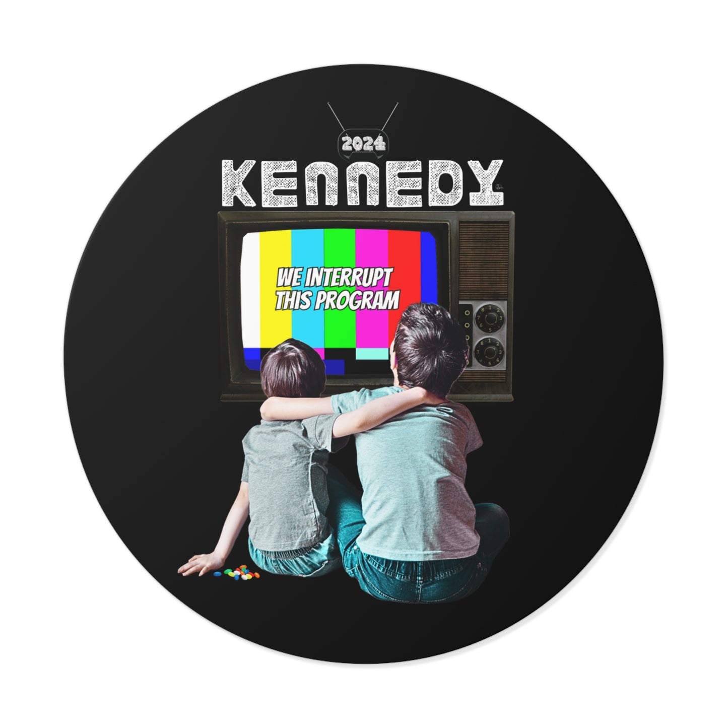 Two children sit on the floor, backs to the viewer, watching a vintage Kennedy TV. The screen shows a color test pattern with the text We Interrupt This Program. A vinyl sticker bearing RFK Jr. and 2024 is prominently displayed above the television.