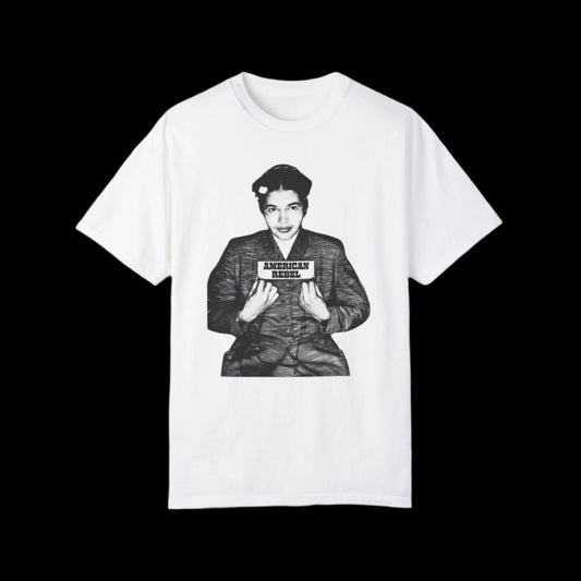 Unisex T-shirt showcasing a black and white image of Rosa Parks' mug shot and holding a sign that reads “American Rebel.” With its plain black background, this piece echoes the rebellious spirit of icons like Rosa Parks.
