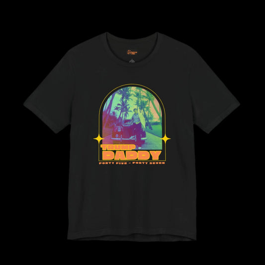 A black retro vintage tee showcasing Donald Trump standing in front of his Rolls-Royce with a colorful palm tree background. The text proudly displays TRUMP DADDY and FORTY FIVE - FORTY SEVEN. Made from 100% cotton, this shirt combines comfort with a nostalgic flair and style.