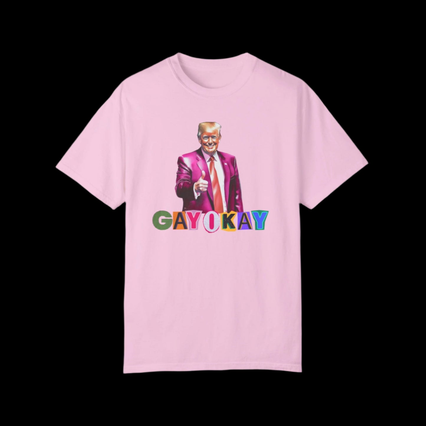 Unisex blossom pink cotton T-shirt featuring a graphic of a person in a pink suit, pointing forward. Below, the text reads GAY OKAY in colorful letters. This bold LGBTQ design is set against a striking black background.
