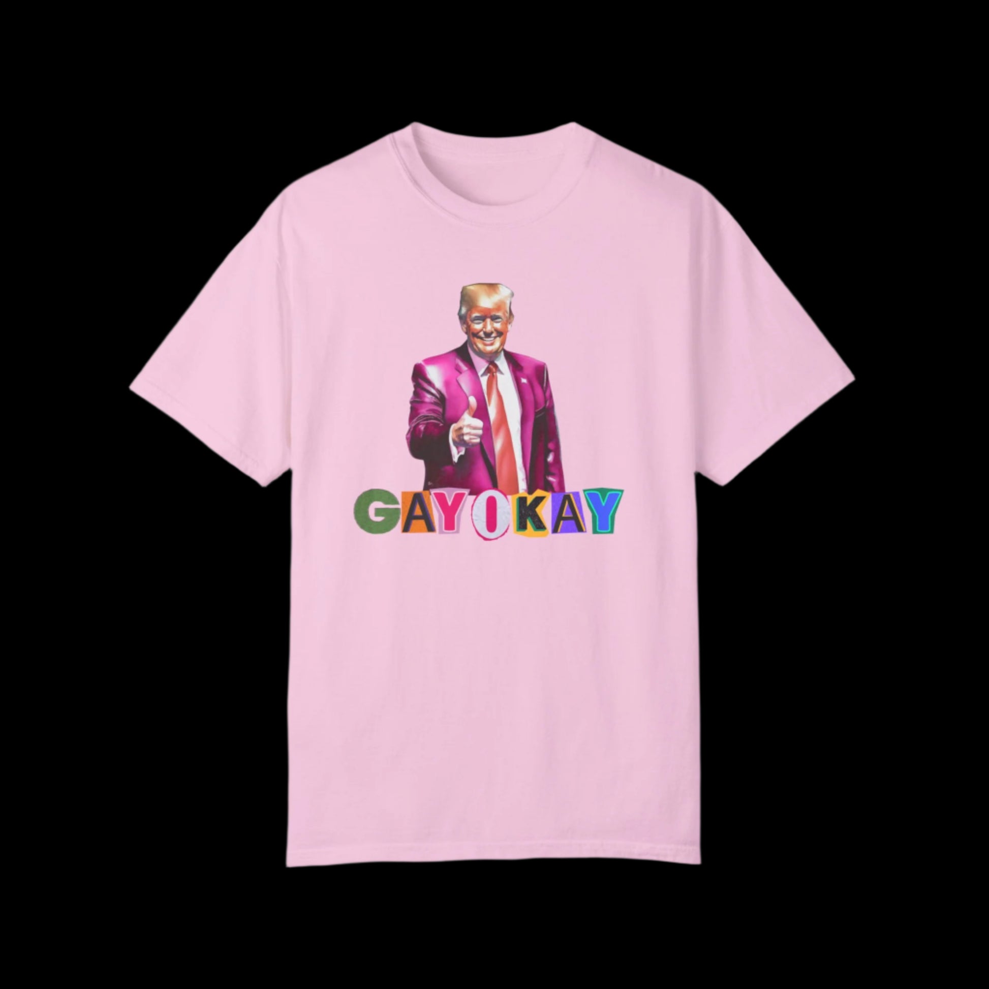Unisex blossom pink cotton T-shirt featuring a graphic of a person in a pink suit, pointing forward. Below, the text reads GAY OKAY in colorful letters. This bold LGBTQ design is set against a striking black background.