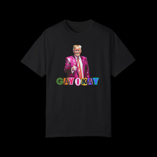 A unisex black cotton T-shirt featuring a vibrant graphic of a person in a pink suit, giving a thumbs up. Below them, the text GAY OKAY is displayed in colorful letters, celebrating LGBTQ pride.