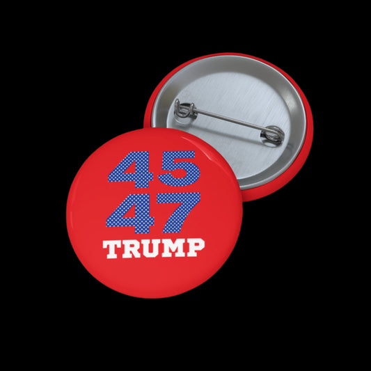 A red pin button labeled Trump-45/47 features numbers in blue with white dots and TRUMP in white. It sits beside another button, revealing its metal back and pin, all against a black background. Assembled in the USA.