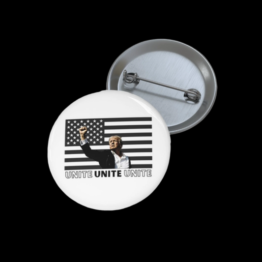 A metal button featuring a black and white American flag pin in the background with a person raising their fist in the foreground. The text UNITE UNITE UNITE boldly appears below, symbolizing strength and solidarity, proudly assembled in the USA.