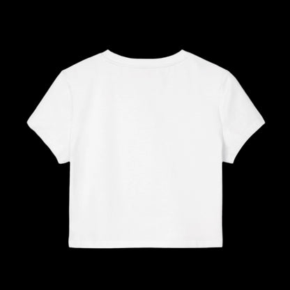 A plain white short-sleeve baby tee is displayed against a black background. The t-shirt is shown facing backward, highlighting its simple design and straight hemline, crafted from soft organic cotton.