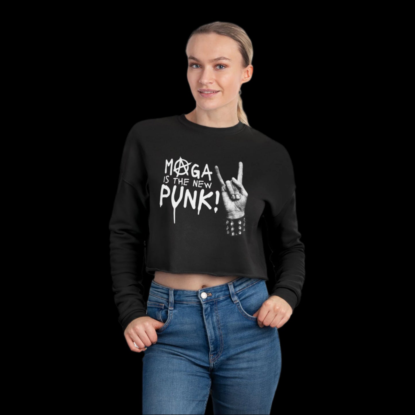 A woman stands against a black background, showcasing a relaxed fit womens black sweatshirt with MAGA is the new Punk! and a hand making a sign. Her light hair falls over the punk cropped sweatshirt, paired with blue jeans for an effortlessly cool look.