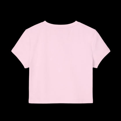 A light pink short-sleeved baby tee is shown on a black background. Crafted from soft organic cotton, the shirt is plain with no visible designs or logos, and the focus is on the back of the garment.